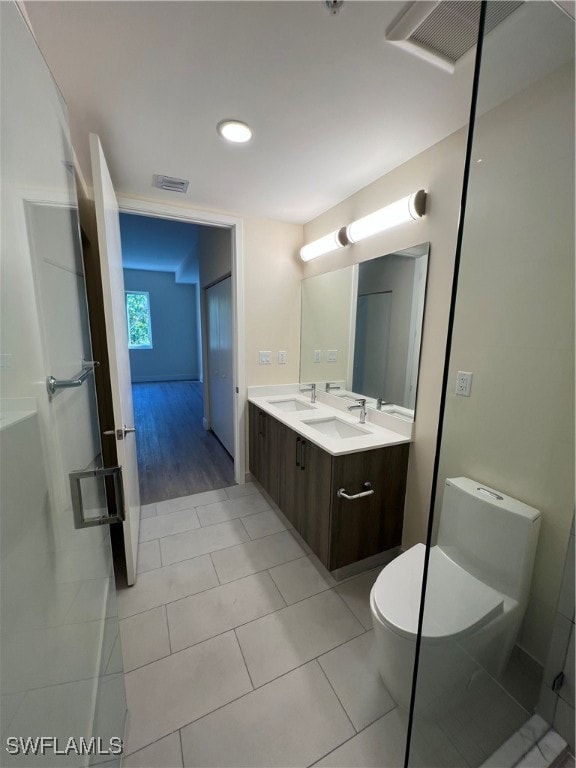 bathroom with vanity, toilet, and tile patterned floors