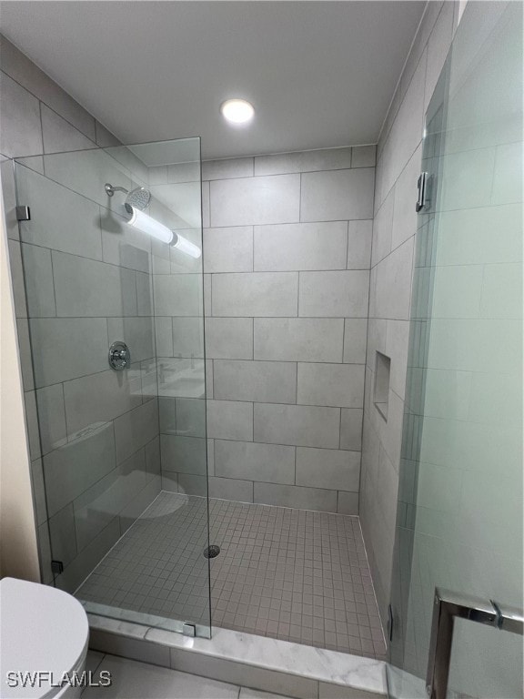 bathroom with toilet and walk in shower