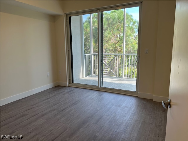 unfurnished room with a wealth of natural light and dark hardwood / wood-style flooring