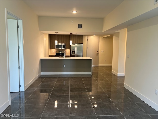 kitchen featuring kitchen peninsula, sink, and appliances with stainless steel finishes