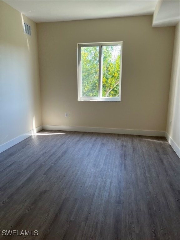 spare room featuring dark hardwood / wood-style floors