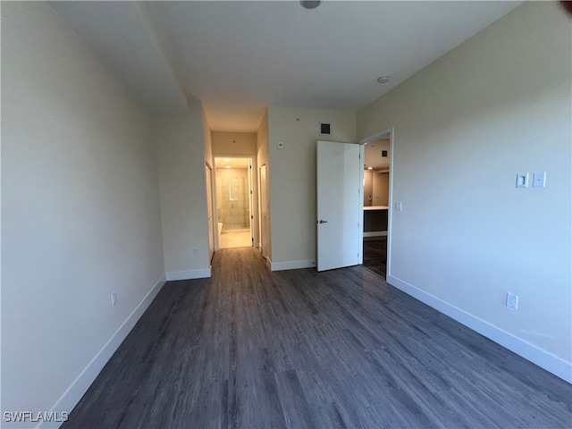 unfurnished bedroom with dark hardwood / wood-style floors