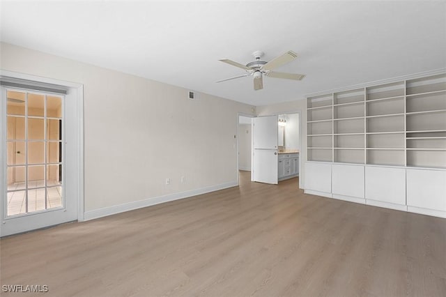 unfurnished bedroom featuring light wood finished floors, baseboards, visible vents, ceiling fan, and ensuite bathroom