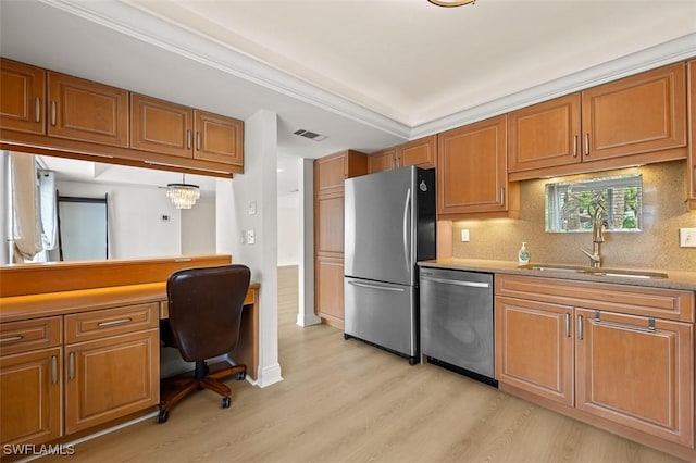 kitchen with tasteful backsplash, appliances with stainless steel finishes, brown cabinets, light wood-type flooring, and a sink