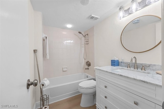 full bathroom featuring visible vents, toilet, shower / tub combination, wood finished floors, and vanity