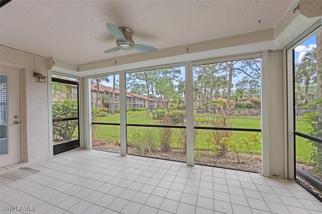 unfurnished sunroom with a ceiling fan