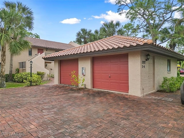 garage featuring decorative driveway