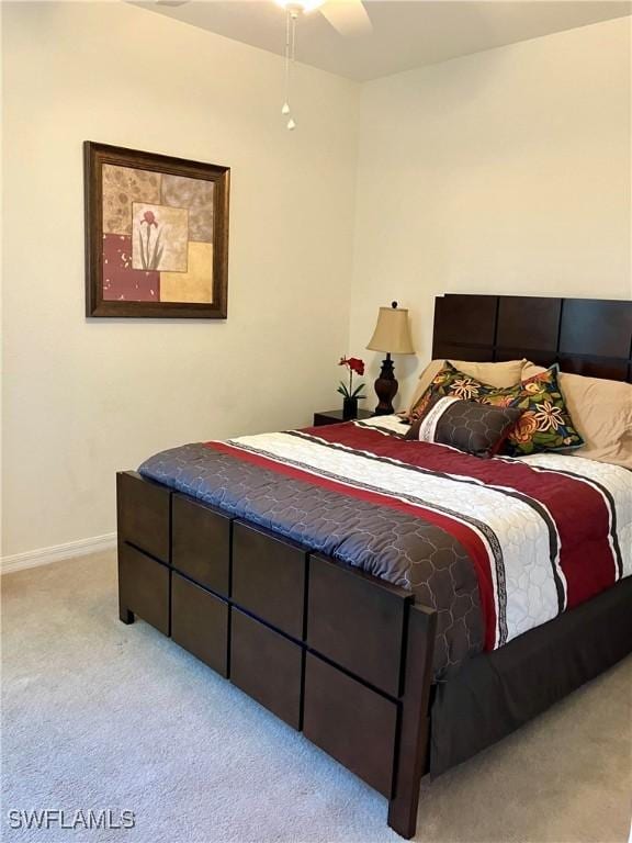 bedroom featuring light carpet and ceiling fan