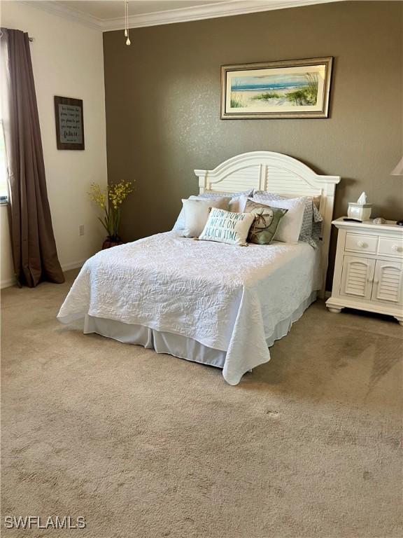 carpeted bedroom with crown molding