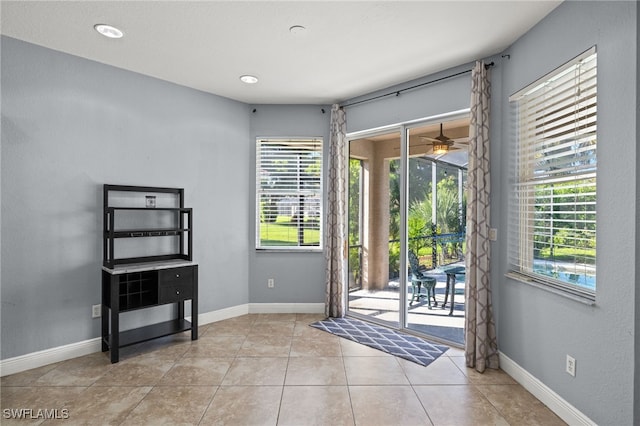 entryway featuring light tile patterned flooring and ceiling fan