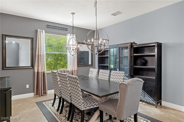 dining area with a chandelier and light tile patterned floors