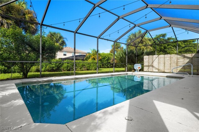 view of swimming pool with a lanai and a patio area