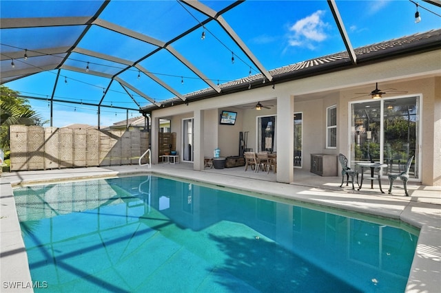 view of swimming pool with a patio area, a lanai, and ceiling fan