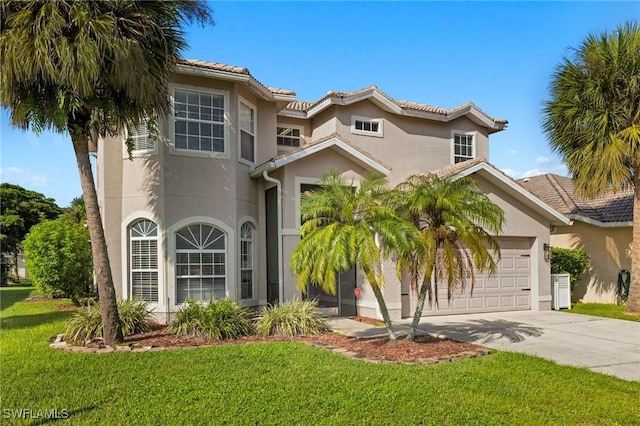 mediterranean / spanish-style house featuring a garage and a front lawn