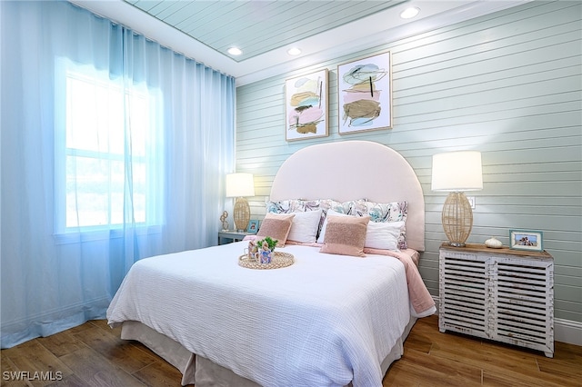 bedroom with wood ceiling and hardwood / wood-style flooring