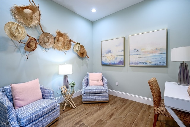 living area with hardwood / wood-style floors