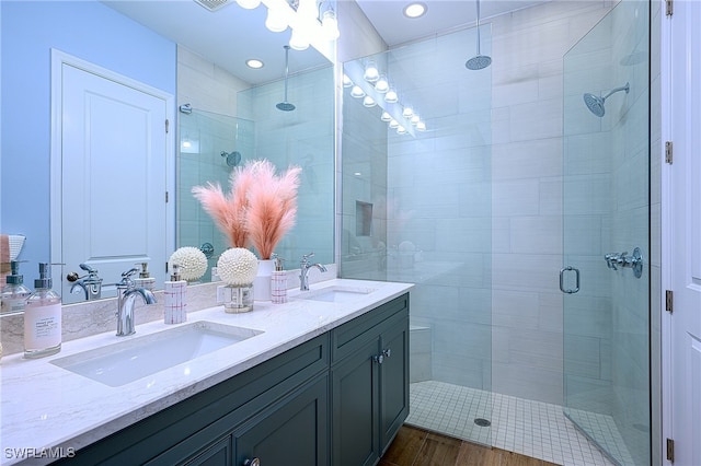 bathroom featuring vanity, hardwood / wood-style floors, and walk in shower