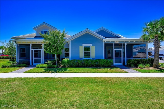 view of front of property with a front lawn and a sunroom