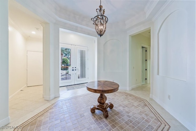 tiled foyer entrance with crown molding and french doors