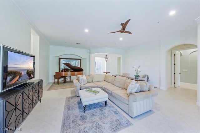 living room with ceiling fan and crown molding