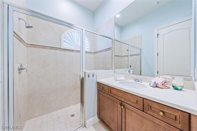 bathroom with vanity and a shower with door