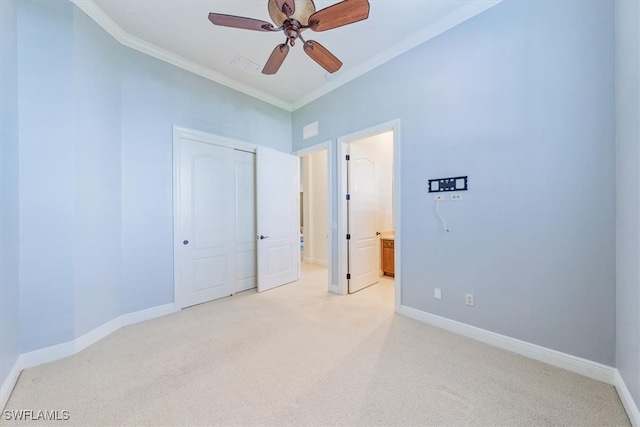 unfurnished bedroom with crown molding, light colored carpet, ceiling fan, and connected bathroom