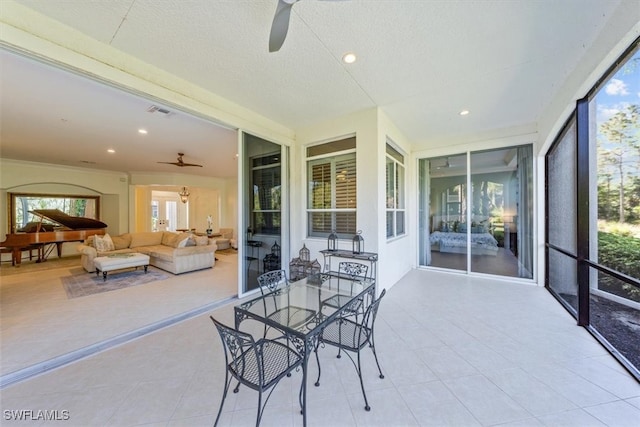 sunroom featuring ceiling fan