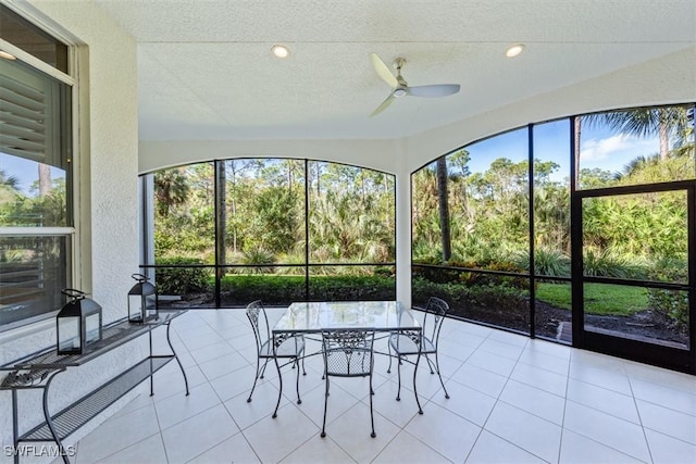 sunroom / solarium featuring a healthy amount of sunlight and ceiling fan