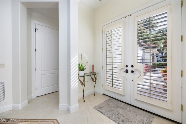 entrance foyer with light tile patterned floors, visible vents, french doors, and baseboards