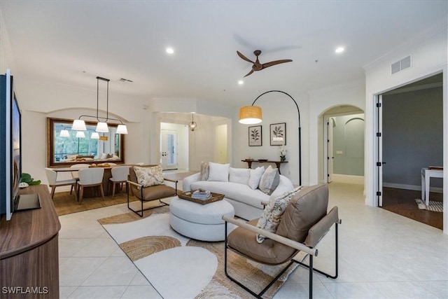 living area with visible vents, recessed lighting, a ceiling fan, and arched walkways