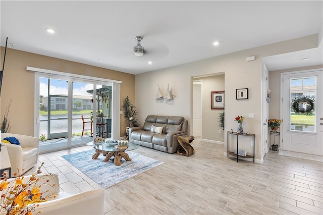 living room with light hardwood / wood-style floors and ceiling fan