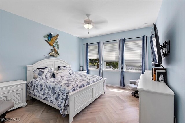 bedroom with ceiling fan and light parquet floors