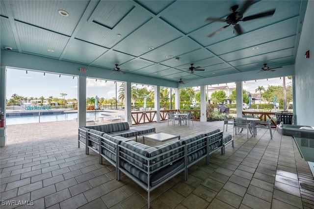 view of patio / terrace featuring a water view, a community pool, and an outdoor hangout area