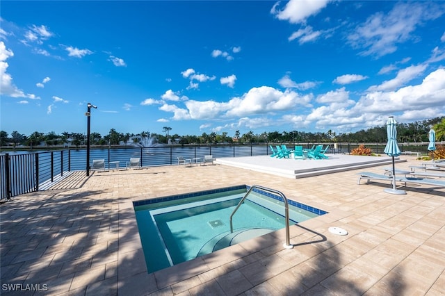 view of pool featuring a hot tub and a patio area