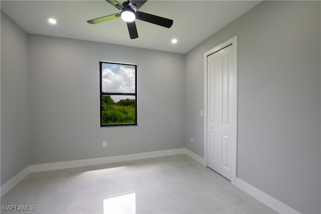 tiled empty room with ceiling fan