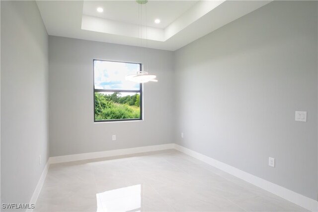 empty room with a raised ceiling