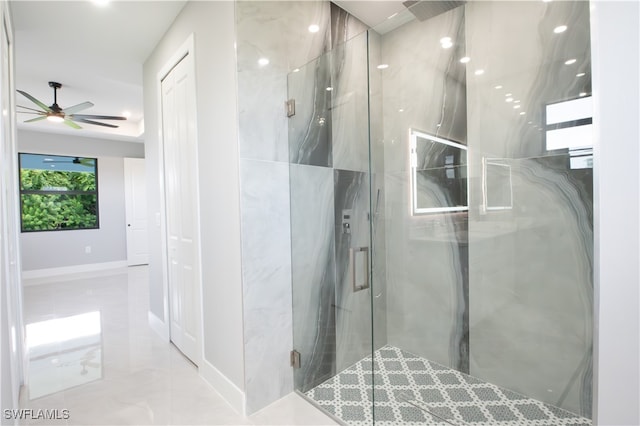 bathroom featuring a shower with shower door and ceiling fan