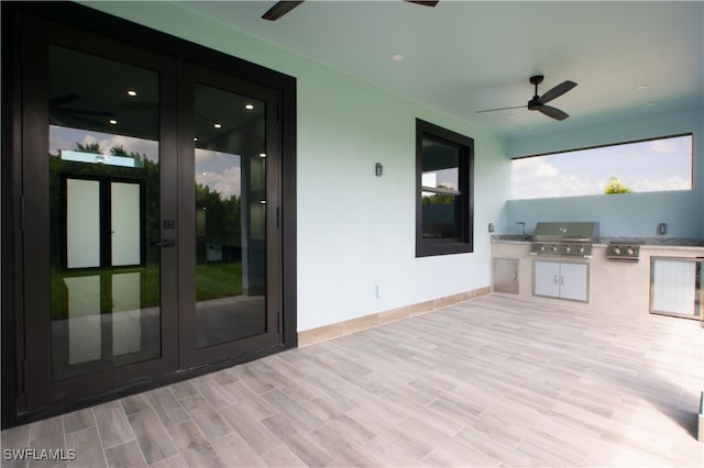 exterior space featuring a grill, ceiling fan, area for grilling, and french doors