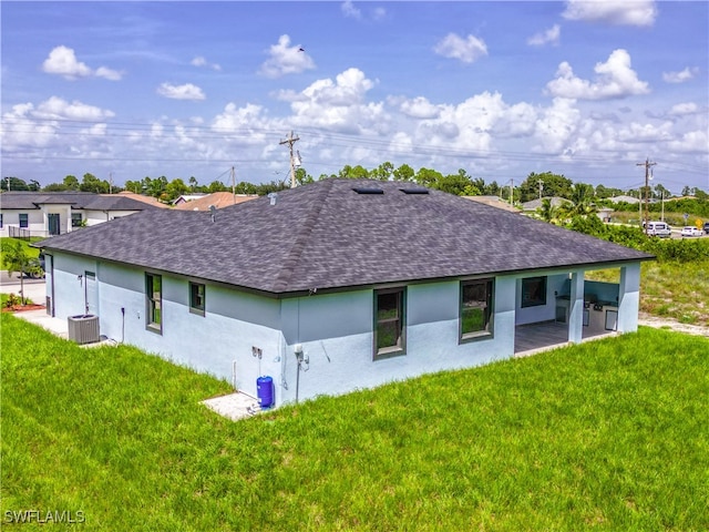 back of property featuring a yard, cooling unit, and a patio