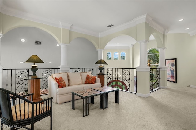 living room featuring crown molding, decorative columns, and light colored carpet