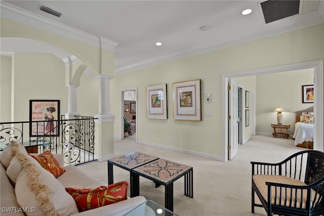 living room featuring crown molding, decorative columns, and light carpet