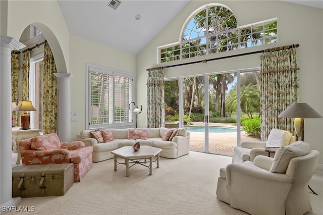 carpeted living room featuring a healthy amount of sunlight and high vaulted ceiling