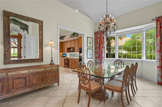 tiled dining space featuring a notable chandelier and vaulted ceiling