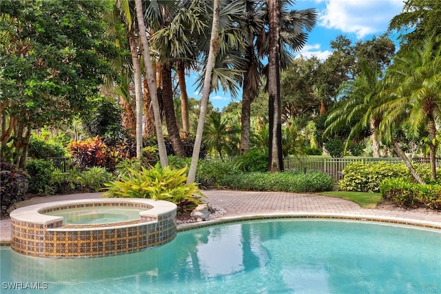 7005 Verde Way, Naples, FL 34108 - view of pool with a pool with connected hot tub and fence