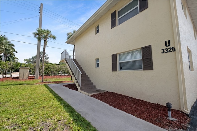 view of side of home with a yard