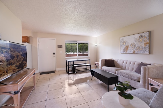 living room with light tile patterned flooring and a textured ceiling