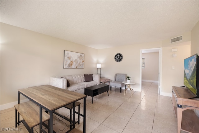 tiled living room with a textured ceiling