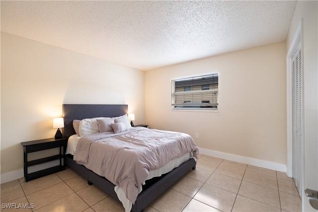 tiled bedroom with a textured ceiling