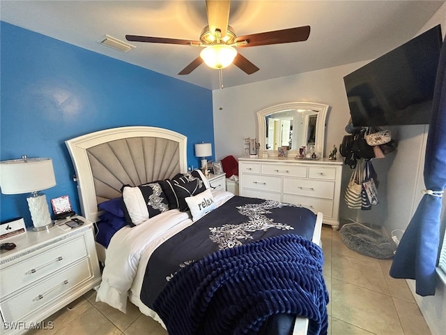 tiled bedroom featuring ceiling fan