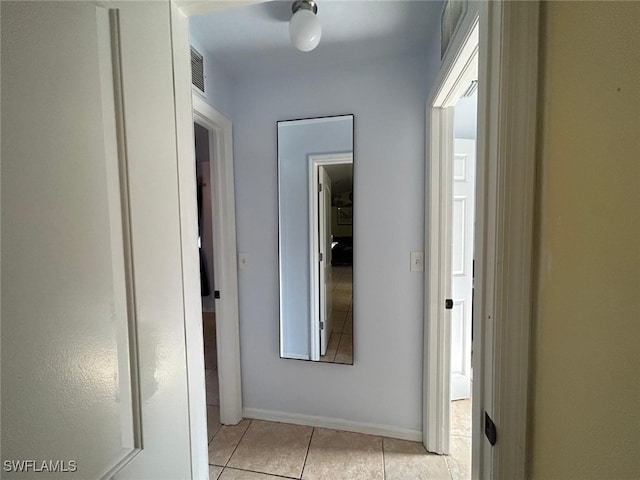 hall featuring light tile patterned floors